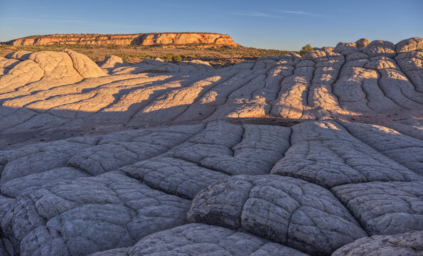 Colorful sandstone formations create unique patterns at White Pocket in Vermilion Cliffs National Monument Arizona during sunset