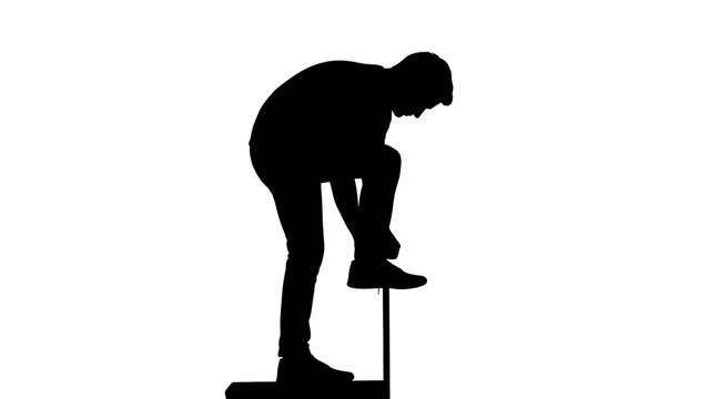 Man bending over to tie shoe.