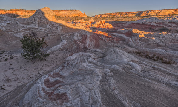Colorful sandstone formations showcase unique geology at White Pocket on the Paria Plateau in Arizona during sunset