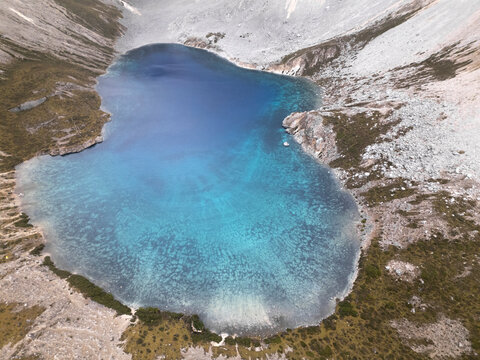 Discovering Five-Color Lake in Yading National Park of Sichuan, China with stunning glacial waters and rocky slopes