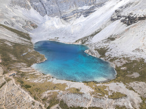 Barren mountain slopes frame deep blue alpine lake in Yading National Park, Daocheng, Sichuan, China
