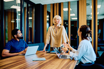 Diverse business professionals discussing projects and ideas, working together in a modern...