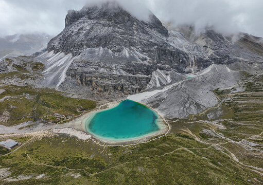 Explore turquoise Milk Lake in Yading Nature Reserve surrounded by mountains in Sichuan, China