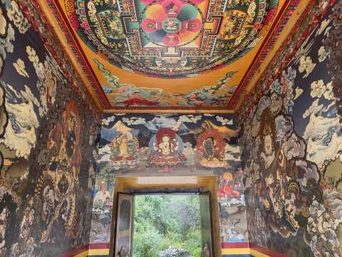 Colorful interior of Tibetan Buddhist temple with detailed paintings in Sichuan, China