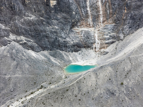 Turquoise lake located in a rocky cirque high in the mountains of Yading Nature Reserve in Daocheng County Sichuan China