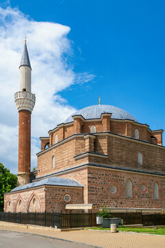 Banya Bashi Mosque with a tall minaret under blue sky in Sofia Bulgaria near the city center and local streets