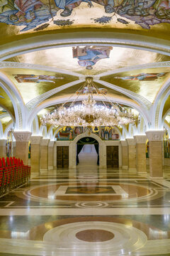 Interior of Church of Saint Sava with golden mosaics, chandelier, and marble floor in Belgrade, Serbia