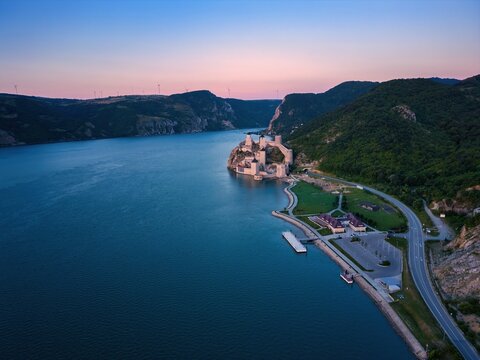 Sunset view of Golubac fortress over Danube river in Serbia taken from a drone high above
