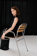 Fototapeta premium Brunette model with bob haircut showcases a chic look in a sophisticated setting.