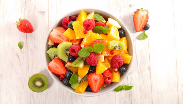 Fresh fruit bowl top view with colorful seasonal produce healthy eating and natural nutrition concept