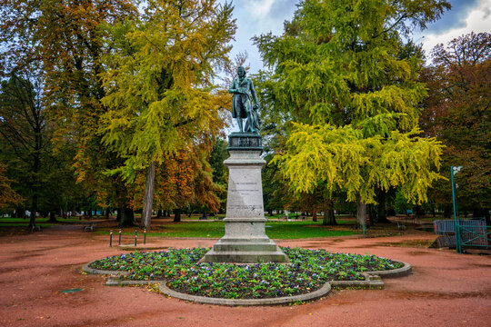 Statue of Claude Louis Berthollet in Jardins de lEurope park surrounded by autumn trees in Annecy France