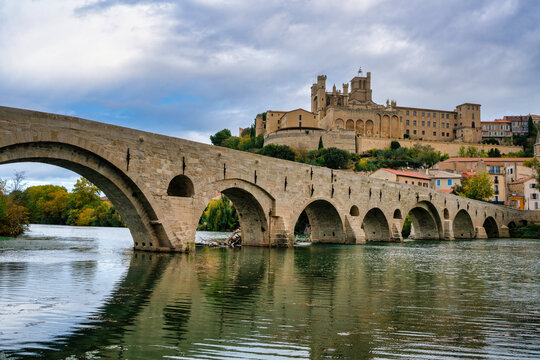 View of Pont Vieux and Saint Nazaire Cathedral by Orb river in Beziers France during afternoon