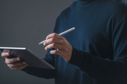 Person using tablet and digital pen representing modern technology, online learning, digital creativity, remote work, business productivity, graphic design, and smart device concepts.