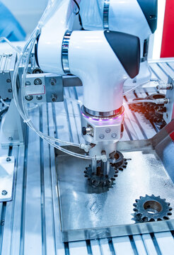 Automated process industrial robot loading metal part. Industrial manufacturing