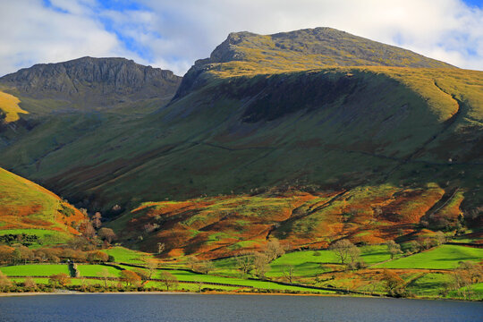 Scafell Pike towers over Wasdale valley in Lake District under a clear sky in Cumbria, United Kingdom