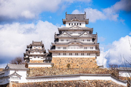 Main keep of Himeji Castle shows traditional architecture from Japan with white walls and stone base in Hygo Prefecture