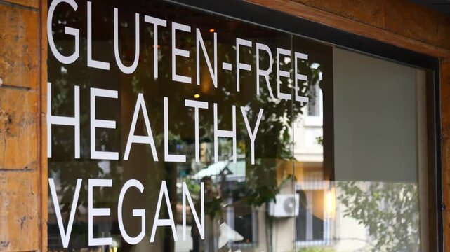 Gluten-free healthy vegan sign on a shop window advertising dietary choices and promoting healthy lifestyle