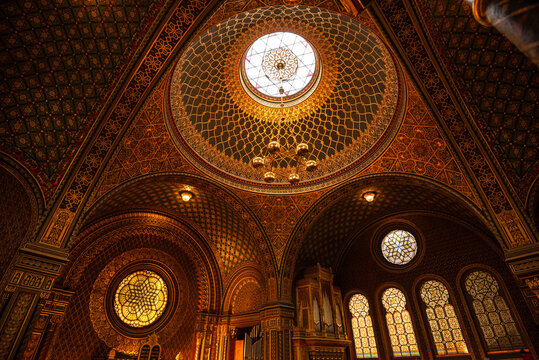 Ornate ceiling and stained glass windows seen inside Spanish Synagogue in Prague