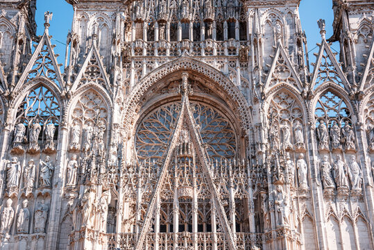 Ornate Gothic facade of Rouen Cathedral showcases intricate details and craftsmanship in Normandy, France