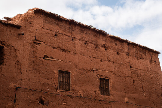 Old adobe house built with mudbrick in a Moroccan village reflecting Berber architecture near the Atlas Mountains