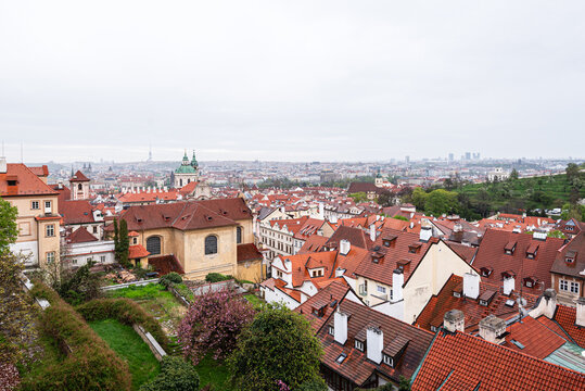 Scenic view of tiled roofs and historic buildings from the terraces of Prague Castle in Mal Strana