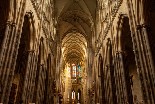 View of the interior of St. Vitus Cathedral during a busy day with visitors exploring the historic site in Prague, Czech Republic