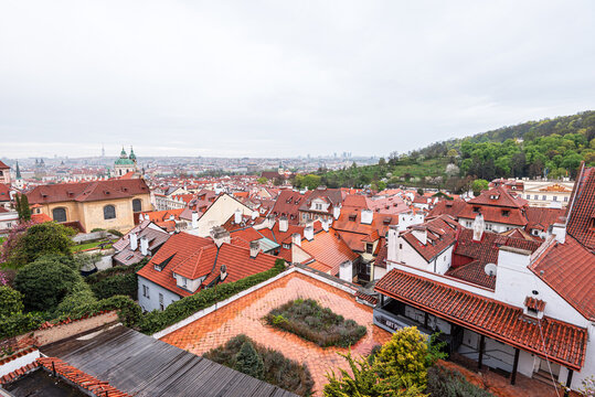 View of red rooftops in Mal Strana with church domes from Prague Castle in Czech Republic