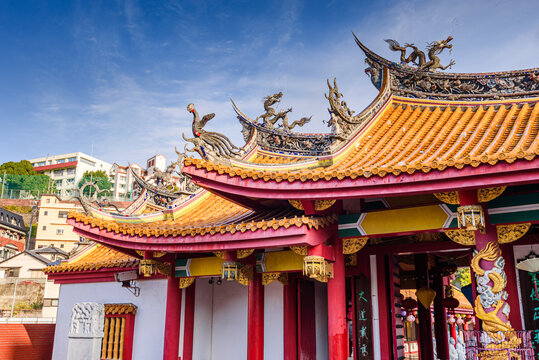 Close-up view of dragon and phoenix decorations atop Confucius Shrine in Nagasaki showcasing cultural symbols of wisdom and strength