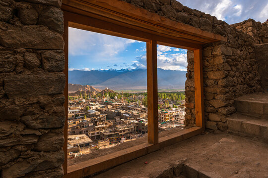 View through a traditional stone window reveals Leh and the Himalayan landscape in India