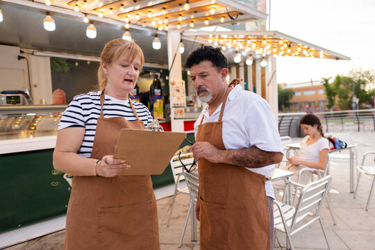 Food truck owners discussing business plan and operations