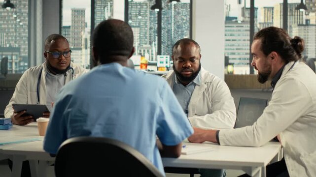Doctors discuss therapy options during a healthcare office session, linking clinical information and treatment notes with the need to support care planning inside a medical team.