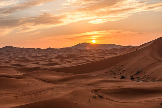 Sunset behind sand dunes in Sahara Desert captures the beauty of nature near Merzouga, Morocco