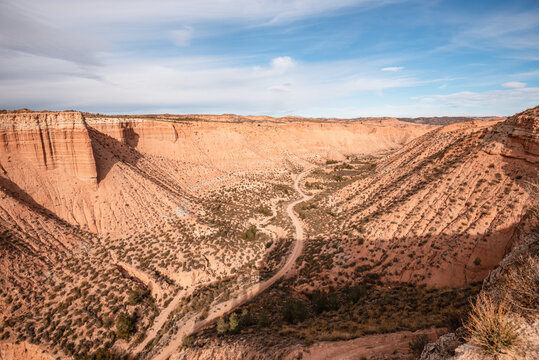 Winding track crosses layered badlands in Gorafe Desert, Granada Province, Andaluca, Spain