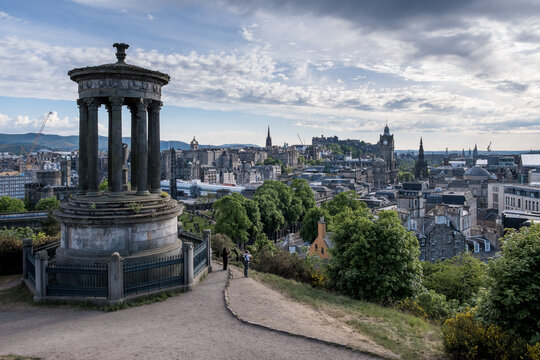 View from Calton Hill showcasing Dugald Stewart Monument and Edinburgh skyline with historical buildings and castle