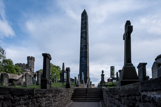 View of Old Calton Cemetery with weathered gravestones and the Political Martyrs Monument in Edinburgh Scotland