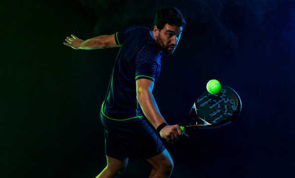 Padel Tennis Player with Racket in Hand. Paddle tenis, on a blue background. Download in high resolution.