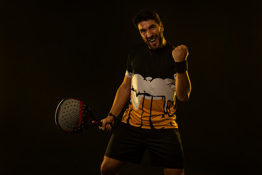 Padel Tennis Player with Racket in Hand. Paddle tenis, on a blue background. Download in high resolution.