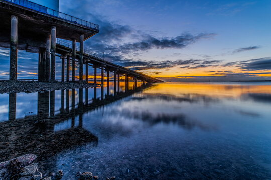 Cold clear sunrise at Roa Island on the Cumbrian Coast with reflections in calm waters on 1st January 2021