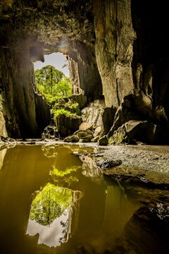 Reflections and rock formations in Cathedral Cavern of Little Langdale Valley during weather in English Lake District, Cumbria UK