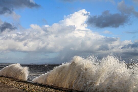 Breezy day along the coast with waves reaching the shore in Roosebeck on the Cumbrian coast in the United Kingdom