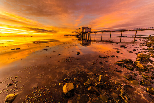 Dramatic sunrise at Roa Island Lifeboat Station on the Cumbrian Coast with a view of Piel Island