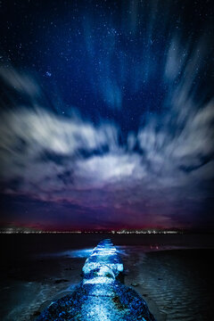 Starry skies over the coast at Sandy Gap on Walney Island during a clear night in the UK