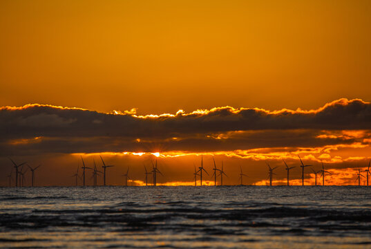 Sunset view over Walney Wind Farms in the Irish Sea near Westmorland and Furness in the UK