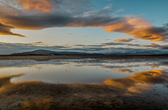 View of the Duddon Estuary with reflections of clouds and mountains at dusk near the Cumbrian Coast
