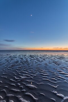 Sunset view from Sandy Gap with beach patterns and water in Walney Island, Cumbria, UK
