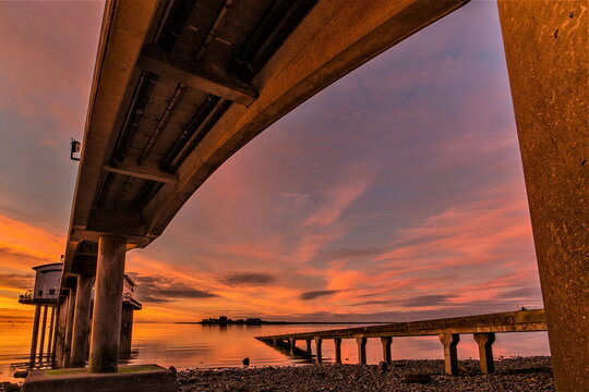 Sunrise over Roa Island showcasing lifeboat station and Piel Castle in the distance on a winter morning in Cumbria