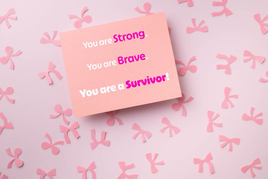 You are Strong, brave, survivor message on pink card with a pink background with awareness ribbons.