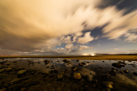 Cloudy night sky over the coast highlights Ursa Major near Black Combe in the Cumbrian region of the United Kingdom