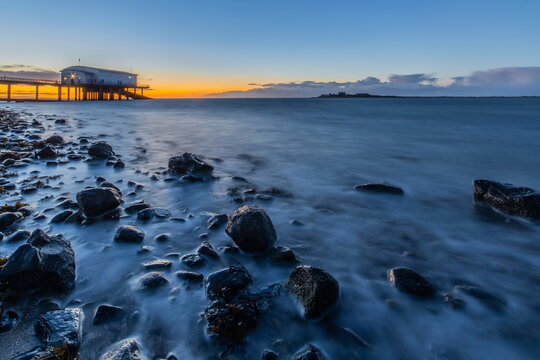 Cold North breeze across Walney Channel towards Piel Island at sunset from Rampside coast in Cumbria