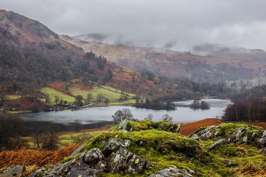 Experience the views of Rydal Lake and surrounding hills in the Lake District during a cloudy day with changing weather patterns
